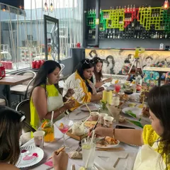 A table of friends enjoying a creative kitty party. I love the vibrant energy and laughter that fills the room during these events.