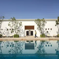 The serene poolside of our hotel project in Bodhgaya, designed as a tranquil sanctuary that encourages reflection. The architecture harmonizes with the water, creating a seamless experience of peace.