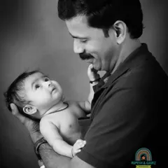 A powerful black and white portrait capturing the gentle gaze between a father and his baby. These classic, emotional shots become timeless family heirlooms.
