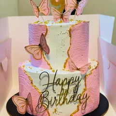 This elegant two-tier butterfly cake is perfect for making any birthday special. With its delicate design and delicious pineapple flavor, it's a beautiful and tasty centerpiece for a girl's birthday party or any celebration needing a touch of grace.