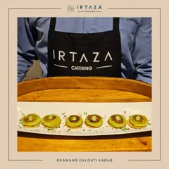 My staff presenting a tray of our modern Edamame Galouti Kebabs, showcasing both the uniform and the elegant serving style.