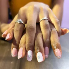 A delicate and romantic design. I created a French manicure look using a fine silver glitter line for the tips and added accent nails with a white base and a silver glitter heart.