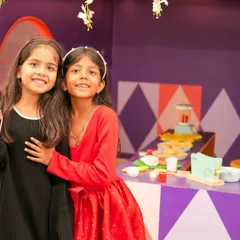 Two friends enjoying our pretend play kitchen. This zone is perfect for fostering social skills and creativity as kids cook up imaginary feasts together.