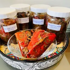 Freshly bottled Banarshi Lal Mirch pickle, ready to be sent out. Each 300-gram jar is filled with spicy stuffed red chilies, ensuring you get that authentic, pungent flavor in every bite.