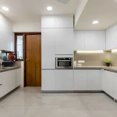 A pristine, all-white U-shaped kitchen I designed. The layout provides an efficient workflow, while under-cabinet lighting and integrated appliances create a bright and modern cooking environment.