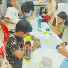 Another group of kids working on their projects, including a custom-designed Robo Car. They get to decorate and build their creations from scratch.