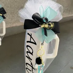 A personalized mug for "Aarti," featuring a football-themed keychain. We can customize these favors to match any party theme, from sports to superheroes.