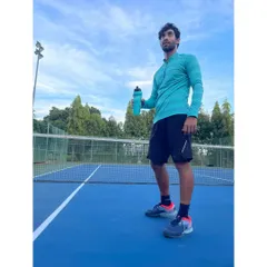 On the court, readiness is everything. This is me between drills, focused and prepared for the next point. My coaching emphasizes not just physical skill but also the mental focus required to compete at a high level.
