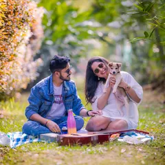 A perfect picnic scene in a grassy meadow, complete with a guitar and a furry friend, showcasing a relaxed and casual photoshoot concept.