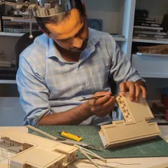 The hands of our master model maker, Vijay, meticulously crafting a detail. Physical models are a critical tool for us to study scale, proportion, and the play of light before construction begins.