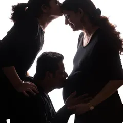 This silhouette style is a beautiful way to include the entire family in a maternity shoot. Here, an older child joins her parents in celebrating the coming arrival of her new sibling.