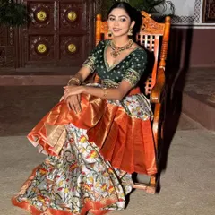 A model looking regal in our rental Kalamkari lehenga. It's a perfect outfit for a photoshoot or a festive event.