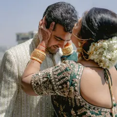 A mother's gentle touch. A candid, emotional moment between the groom and his mother on his wedding day.