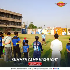 A group of young cricketers listens intently to their coach. Our camps are designed to be fun, engaging, and highly educational.