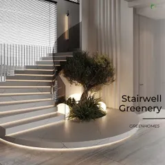 A beautiful faux olive tree is set within a curved, marble-clad platform at the base of a spiral staircase. The integrated LED lighting along the base accentuates the clean lines and makes the tree a sophisticated focal point.