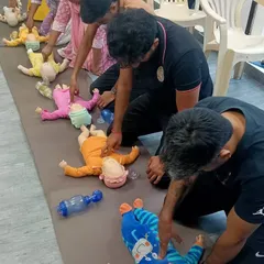 My safety training extends to all ages. This photo shows our group practicing infant CPR, a specialized skill that requires precision and care.