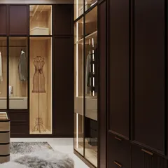 The wardrobe includes display niches, like this one with a mannequin, adding a touch of high-fashion boutique styling to the personal space.