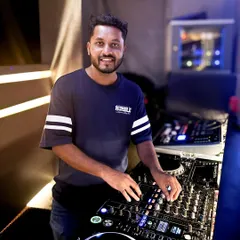 Here I am in my element, ready to spin the tracks that will make your event a hit. I love connecting with the crowd, and this shot captures me getting ready for another great night of music in Bangalore.