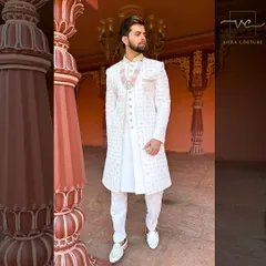 The full look of our white embroidered sherwani. Paired with white trousers and shoes, it creates a stunning, cohesive outfit for a day wedding.