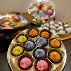 My chocolate modaks come in beautiful gift boxes, showcasing the vibrant colors of flavors like mango, pista, and blueberry. They are a modern twist on the traditional prasad and are perfect for sharing with family and friends.