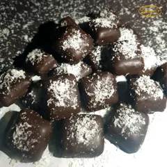 Our classic coconut chocolates. These are soft, chewy squares of coconut fudge dipped in dark chocolate and sprinkled with desiccated coconut for a perfect finish.