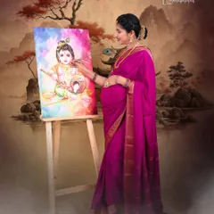 An expectant mother dressed in a beautiful pink saree adds the final touches to a painting of Little Krishna. This creative concept, set against a traditional painted backdrop in our studio, connects the mother's love to a divine theme.