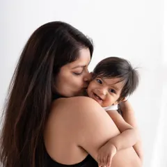 A sweet and tender moment between a mother and her baby, full of love and happy giggles.