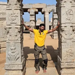Standing between the intricately carved pillars of the Veerabhadra temple. Every pillar in Lepakshi tells a different story from Hindu mythology.