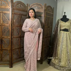 A full-length view of the pink sequin saree, showing its beautiful drape and all-over sparkle.