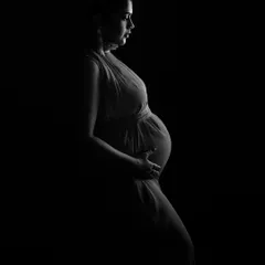 Another variation of the low-key profile, showcasing the elegance of the mother's form in a simple, artistic way.