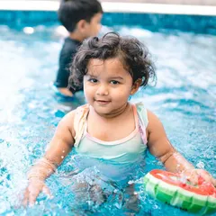 A happy splash in the pool. Event photography is about capturing all aspects of the celebration, including the fun and playful moments like this.