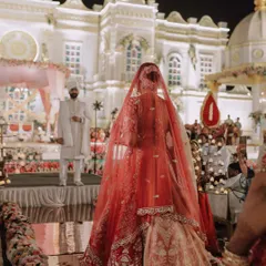 A bride's grand entrance is a story in itself. We capture this pivotal moment from a unique perspective, highlighting the magnificent venue, the traditional elements, and the groom's eager anticipation.