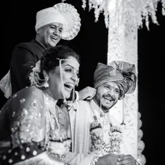Pure, unadulterated laughter during a wedding ceremony. This candid black and white shot freezes a moment of joy between the couple and their family, making it timeless.