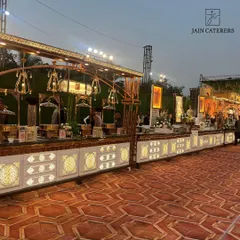 An elegant, illuminated buffet counter ready for an evening of celebration. The warm lighting and intricate details of the setup create an inviting atmosphere for guests to enjoy their meal.