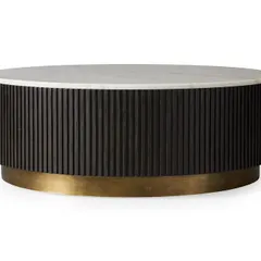 This custom coffee table features a fluted wood base with a brass ring and a clean white marble top. It's a perfect example of how we mix materials to create furniture with a modern and sophisticated feel.