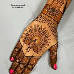 A graceful back-of-hand design featuring a sun-like mandala with a peacock at its center. The wrist is adorned with a palace and lotus motif, creating a beautiful composition.