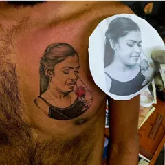 Creating a realistic portrait tattoo requires precision. Here, you can see the final tattoo on the client's chest placed next to the original reference photograph, showing how I accurately capture the likeness and emotion of the subject.