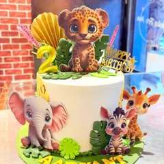 A cute and modern jungle animal cake for a second birthday. This design features adorable, cartoon-style fondant animals like a leopard, elephant, and zebra.