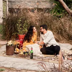 A cozy picnic scene in a rustic, grassy setting, perfect for a relaxed and intimate pre-wedding shoot.