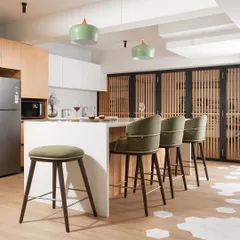 For the Yadalam residence, we converted a dark basement into a bright, minimalist home. The open kitchen features a clean white island, olive green bar stools, and light wood tones to maximize the feeling of space and light.