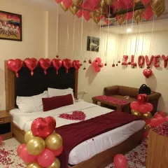 This angle shows the heart-shaped foil balloons lining the headboard, adding an extra touch of love.