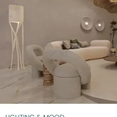 Lighting and mood are crucial. Here, sculptural chairs and a unique floor lamp create an artistic and inviting corner.