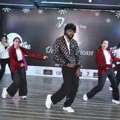 The group moves in sync during their performance, dressed in festive sequined jackets. We also help with costume ideas for performances.