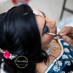 A behind the scenes shot showing the careful application of the blue eyeshadow. Creating a perfect smokey eye requires precision and layering to achieve depth and a smooth gradient.