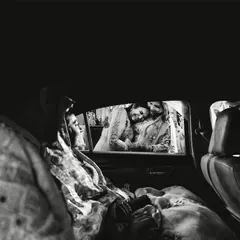 An emotional goodbye. This black and white shot from inside the car captures the poignant moment of the vidaai, a daughter's farewell to her family.