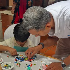 A father and son bonding over a creative project. It's wonderful to see parents get involved and help their kids create their mosaic masterpieces.