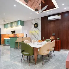 This open-plan layout in Sector 22, Noida, seamlessly connects the kitchen and dining areas. I used consistent flooring and a complementary color palette to create a sense of flow, making the entire space feel larger and more sociable.
