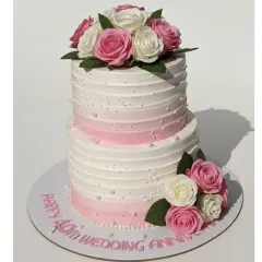 Forty years of love is a milestone worth celebrating in style. I crafted this elegant two-tiered cake with a fresh pineapple flavor and a beautiful pink ombre buttercream design, adorned with fresh roses for a timeless look.