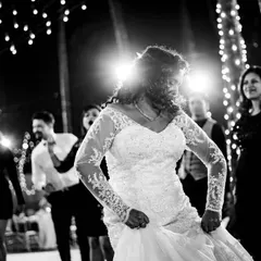 The bride lets loose on the dance floor. This high-energy, black and white shot captures the fun and freedom of the wedding party.