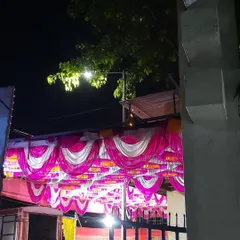 A beautifully decorated pandal ceiling with pink, white, and yellow drapes. This kind of ceiling work adds a grand, festive touch to any outdoor event.